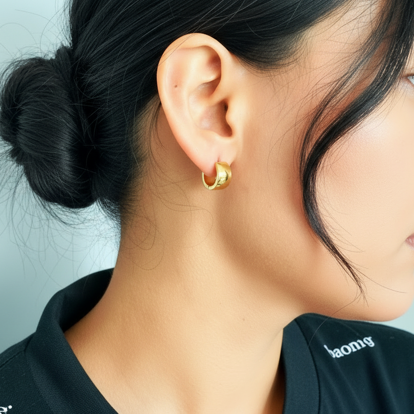Close-up of a woman wearing gold earrings with a blurred background