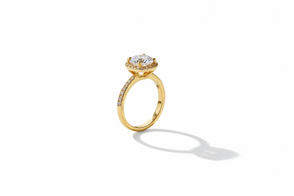 Gold ring with diamonds on a reflective surface